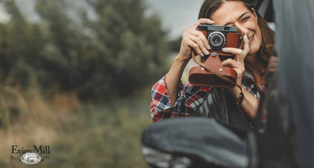 Woman taking photos of nature from her vehicle